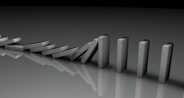 Unlabeled dominoes, falling in sequence.